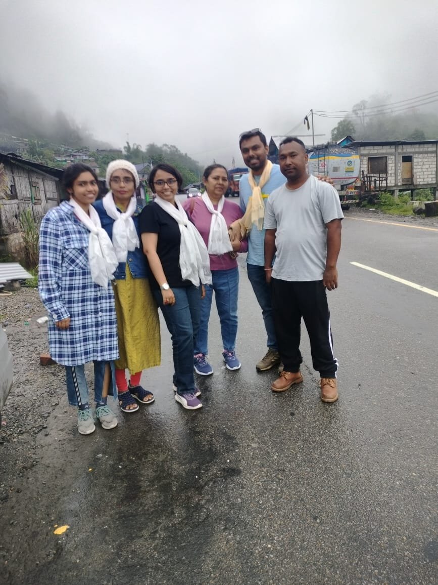 Happy family guests welcomed with traditional khadas on a Dorjee Tours trip