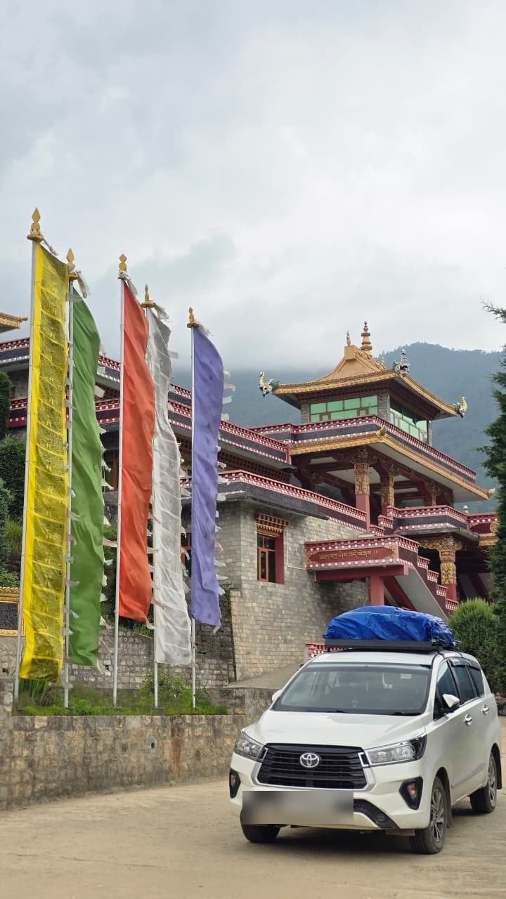 Innova Crysta at Dirang Monastery with prayer flags